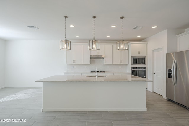 kitchen featuring white cabinetry, hanging light fixtures, a center island with sink, and black appliances