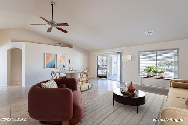 tiled living room featuring ceiling fan and vaulted ceiling