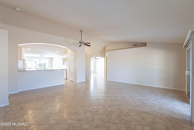 unfurnished room with ceiling fan, light tile patterned floors, and vaulted ceiling