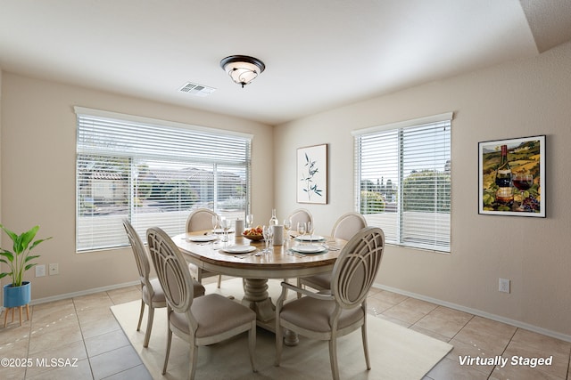 dining space featuring light tile patterned floors