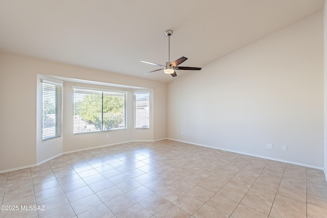 unfurnished room with vaulted ceiling, ceiling fan, and light tile patterned floors