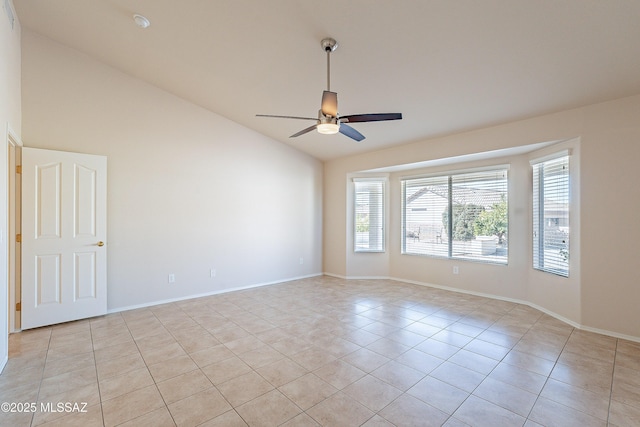 spare room featuring ceiling fan, light tile patterned floors, and lofted ceiling