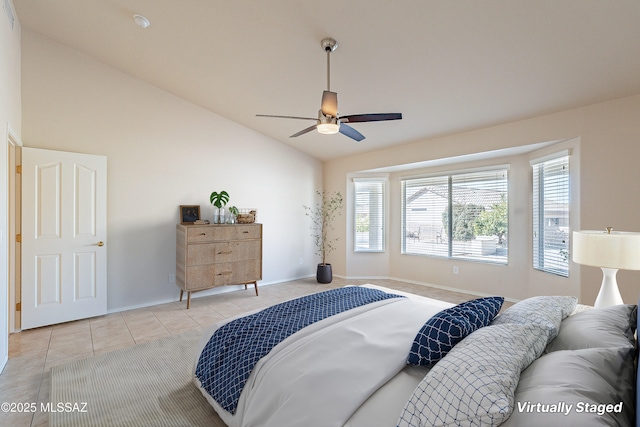 tiled bedroom with ceiling fan and lofted ceiling