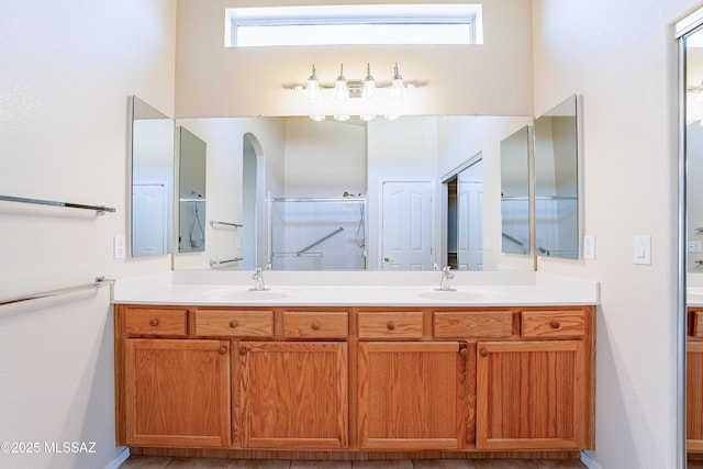 bathroom with vanity and a shower with door