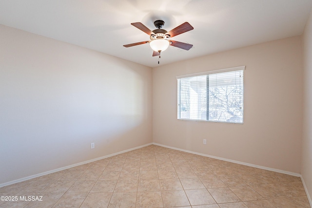 empty room with ceiling fan and light tile patterned floors