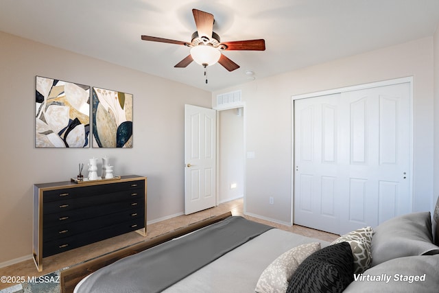 bedroom featuring a closet, light tile patterned floors, and ceiling fan