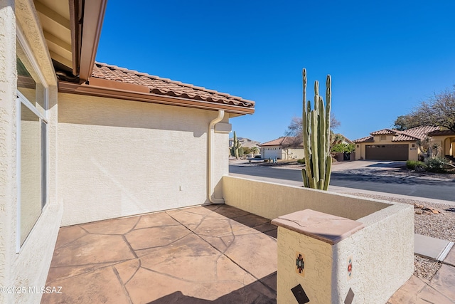 view of patio / terrace featuring a garage