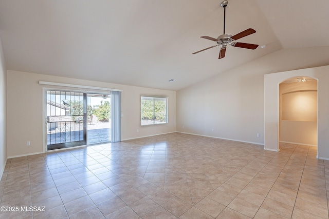 empty room with ceiling fan, light tile patterned floors, and vaulted ceiling