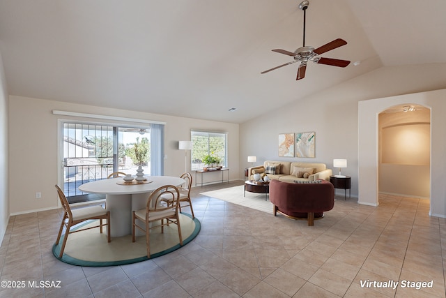 tiled dining room featuring ceiling fan and vaulted ceiling