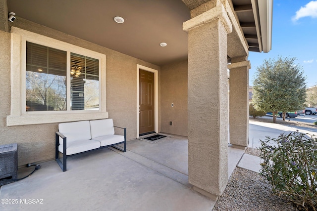 view of exterior entry with a patio