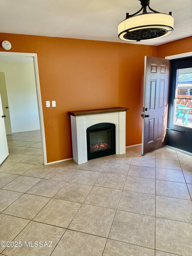 interior space with light tile patterned floors, blue cabinetry, backsplash, black fridge, and sink