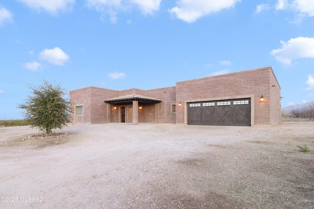 pueblo revival-style home with a garage