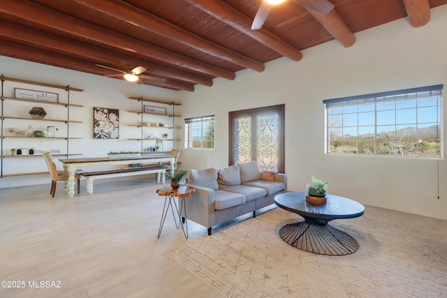 living room featuring wooden ceiling, ceiling fan, light hardwood / wood-style flooring, and beamed ceiling