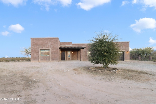 pueblo-style home featuring a garage