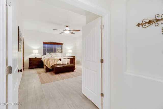 bedroom featuring ceiling fan and light hardwood / wood-style flooring