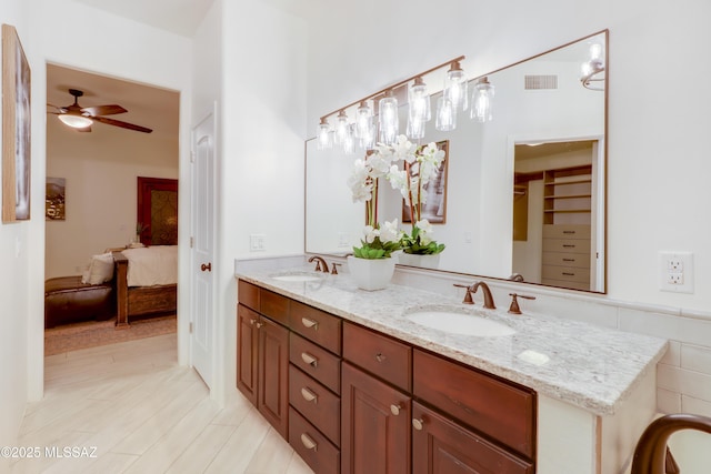 bathroom featuring ceiling fan and vanity