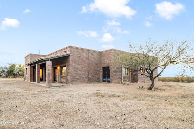 rear view of property featuring a patio area