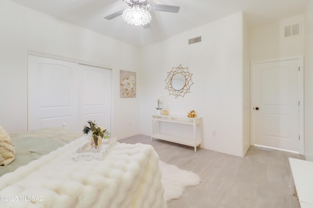 bedroom with ceiling fan, a closet, and light wood-type flooring