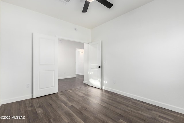 unfurnished bedroom featuring ceiling fan and dark wood-type flooring