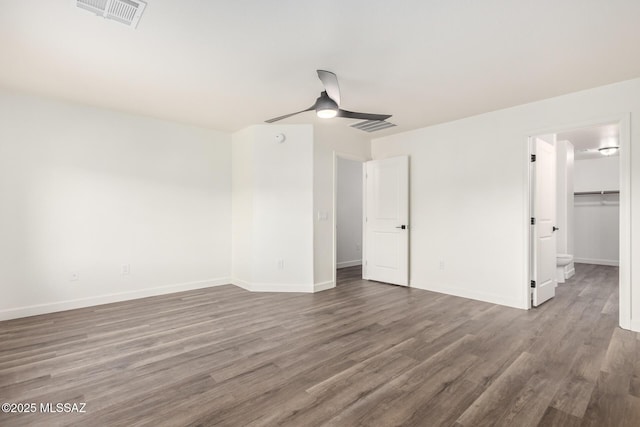 spare room with dark wood-type flooring and ceiling fan