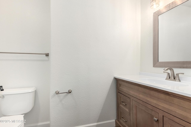 bathroom featuring toilet and vanity