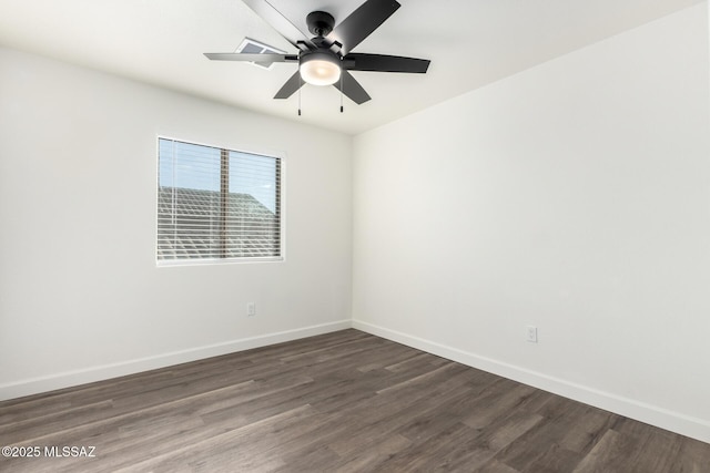 spare room featuring ceiling fan and dark hardwood / wood-style floors