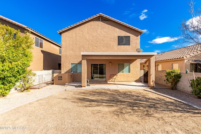 rear view of property featuring a patio area