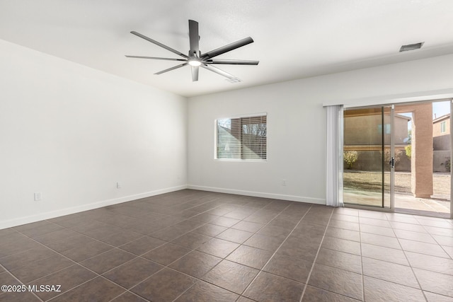 tiled empty room with ceiling fan and a healthy amount of sunlight