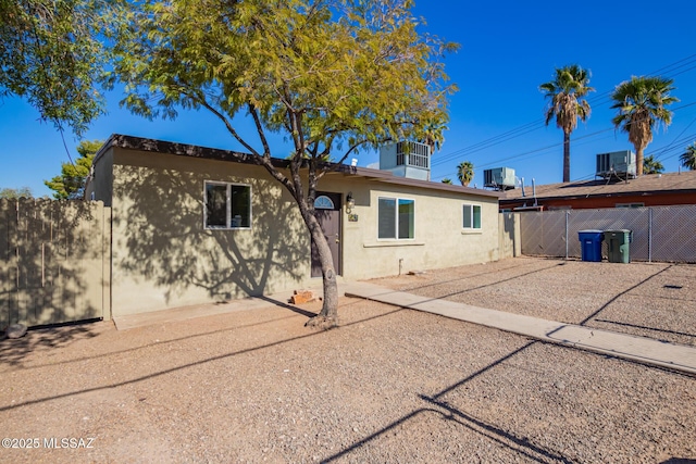 back of property featuring central AC