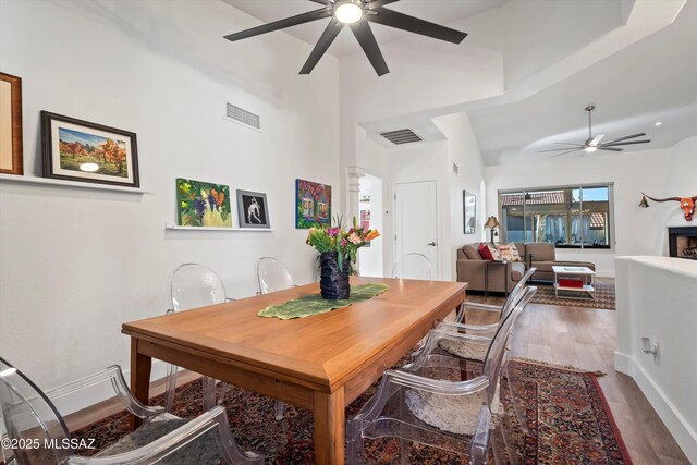 dining space with hardwood / wood-style flooring and ceiling fan