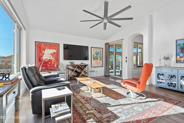 living room with vaulted ceiling, wood-type flooring, a healthy amount of sunlight, and ceiling fan