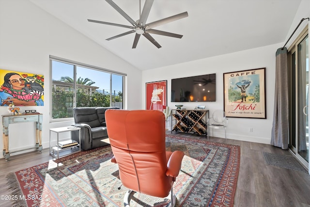 living room featuring vaulted ceiling, dark hardwood / wood-style floors, and ceiling fan