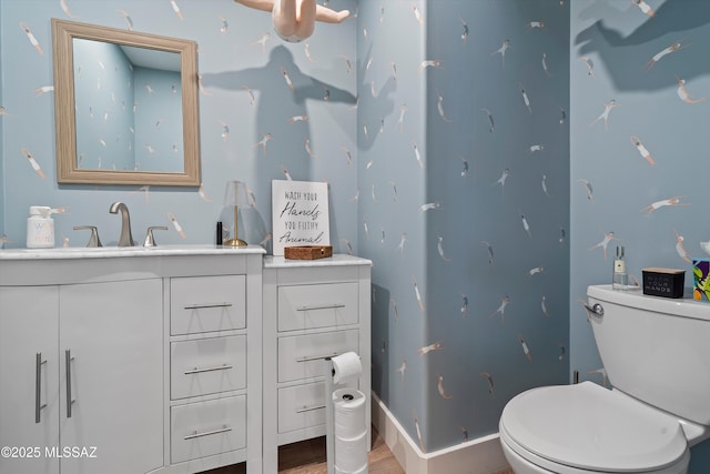 bathroom with vanity, toilet, and hardwood / wood-style floors