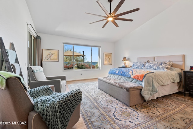 bedroom with lofted ceiling, hardwood / wood-style floors, and ceiling fan