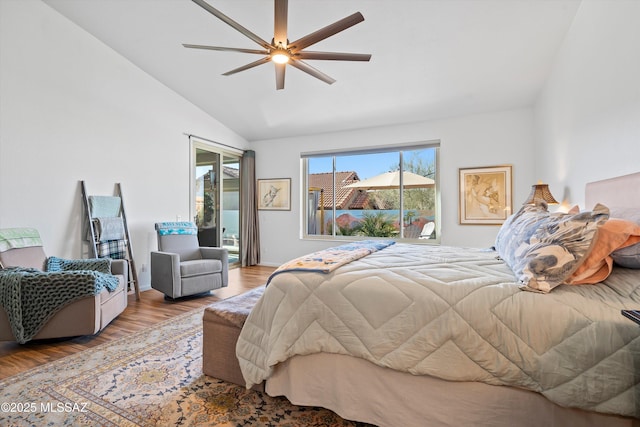 bedroom with light hardwood / wood-style flooring, access to outside, ceiling fan, and vaulted ceiling