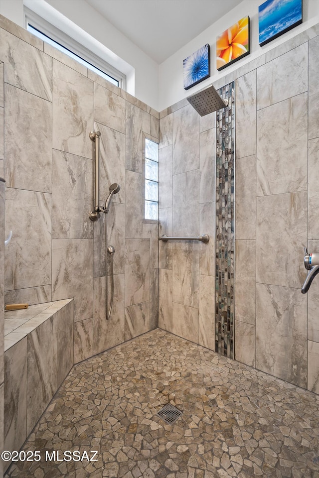 bathroom with a tile shower