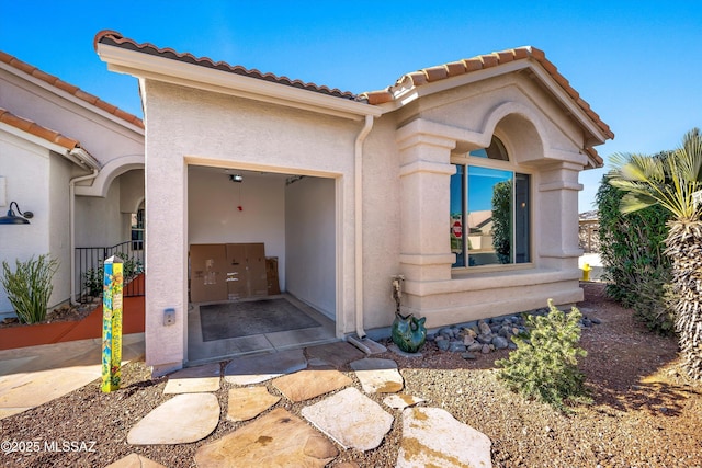 view of exterior entry with a garage