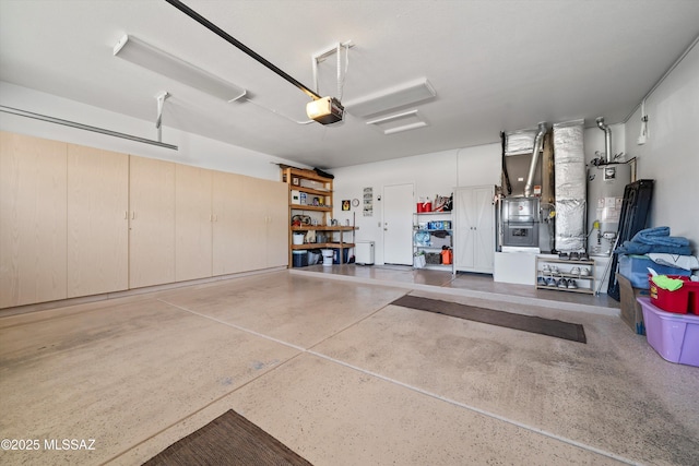 garage featuring heating unit, a garage door opener, and gas water heater