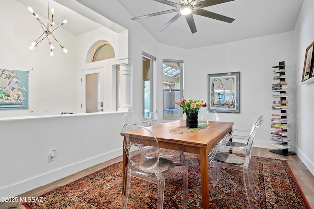 dining area with ceiling fan with notable chandelier and light hardwood / wood-style floors