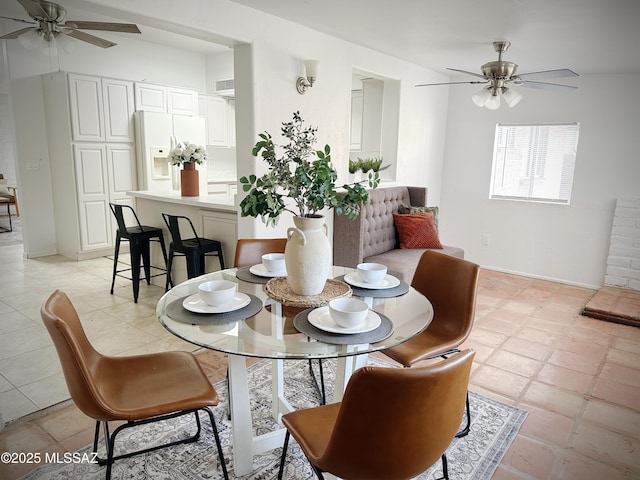 tiled dining room featuring ceiling fan