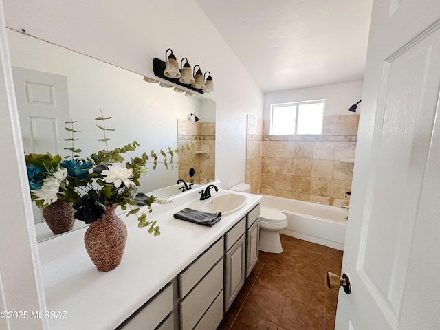 full bathroom with toilet, tiled shower / bath, tile patterned flooring, and vanity