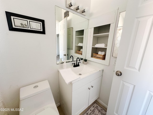 bathroom with toilet and vanity