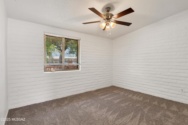 spare room with ceiling fan, carpet, brick wall, and lofted ceiling