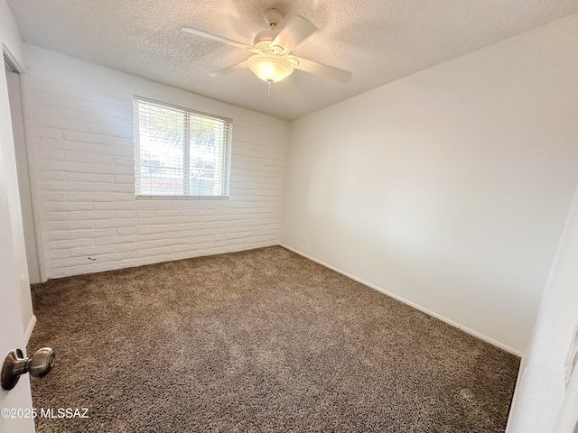 empty room with a textured ceiling, ceiling fan, and carpet flooring