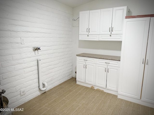 washroom with cabinets and light hardwood / wood-style flooring