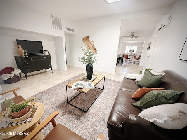 living room with ceiling fan and a wall unit AC