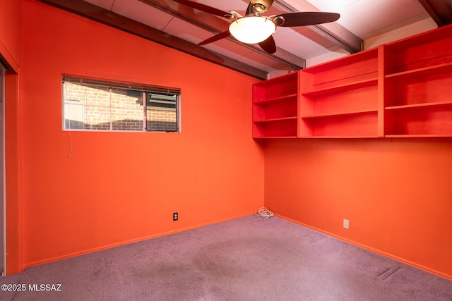 empty room with ceiling fan, lofted ceiling with beams, and carpet