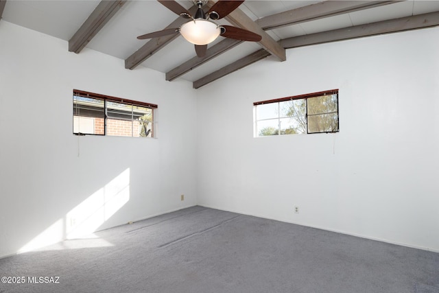 carpeted empty room with vaulted ceiling with beams, a healthy amount of sunlight, and ceiling fan