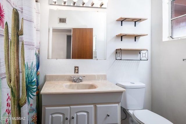 bathroom with vanity and toilet