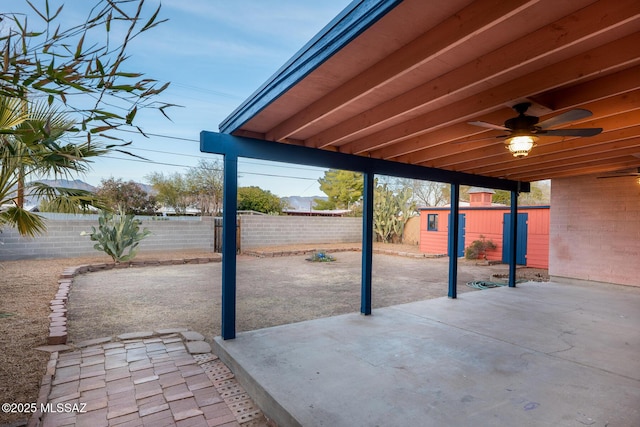 view of patio / terrace featuring a storage shed and ceiling fan